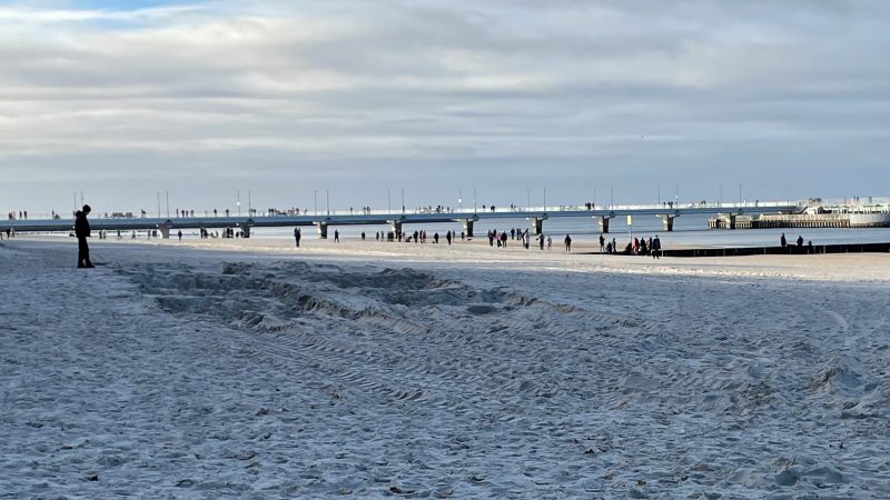 widok na plaże morze i molo w Kołobrzegu, spacerujących ludzi